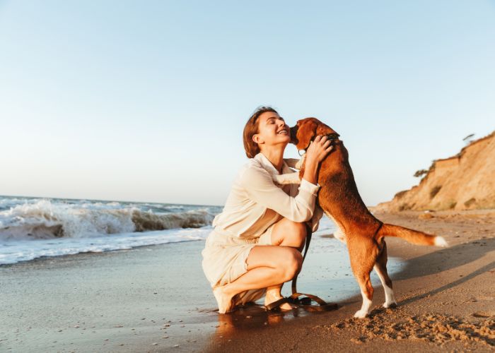 Frau mit Hund am Meer