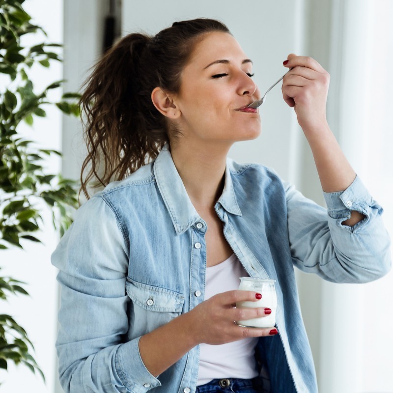 happy woman eating probiotics